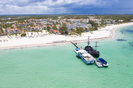 Aerial view from drone on caribbean sea coastline with resorts and wooden pier. Tropical...