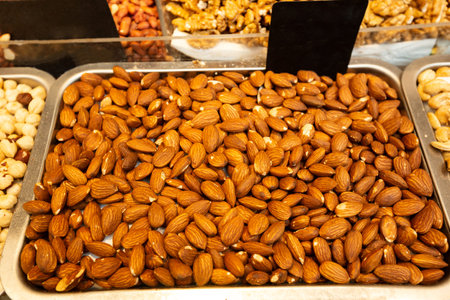 A lot of almonds in box on sale at farms market, selective focus