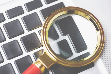 Magnifying lens on laptop keyboard, nobody