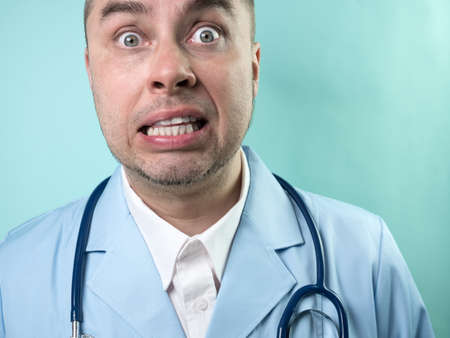 Shocked Doctor in professional medical suit with stethoscope, closeupの写真素材
