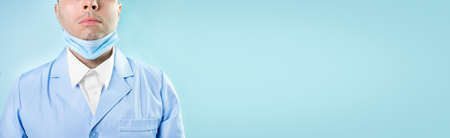 Doctor in professional medical suit with stethoscope and protective medic mask, closeupの写真素材
