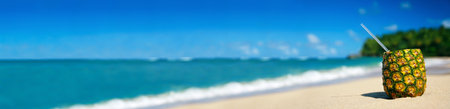 Pineapple cocktail on sand on caribbean beach. Travel summer vacation. Tropical destinations. Punta Cana. Dominican Republic. Long banner with copy space for your textの写真素材