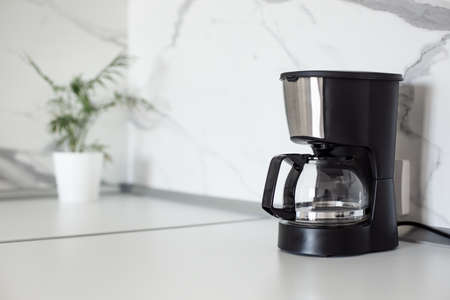 Auto Drip Coffee Maker on white countertop. Electric Kitchen Small Appliance. Domestic & Household deviceの写真素材
