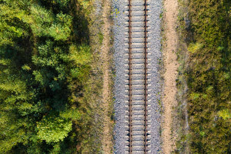 Railway through autumn forest. Aerial view from droneの写真素材
