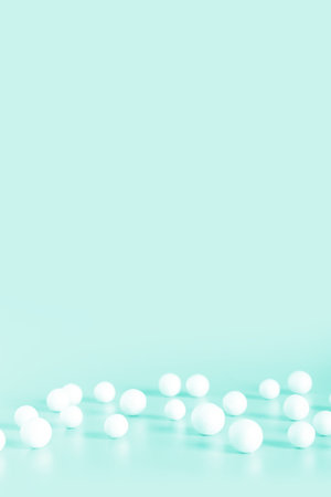 White bubbles and spheres on mint color background. Copy space for text