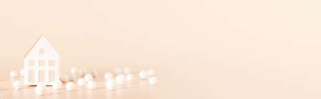 Miniature white toy house on orange color pastel background with abstract balls. Mortgage property insurance home conceptの写真素材