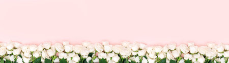 Botanical floral holiday card mockup, white roses flat lay, flower-filled frame on pink color...