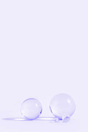 Astract backdrop with glass spheres on pastel lavender color background with sun reflections, monochromeの写真素材