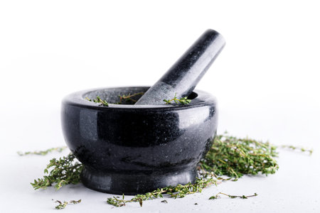 Bunch of fresh herbs in gray stone mortar, rosemary and thyme spices for aromatic culinaryの写真素材