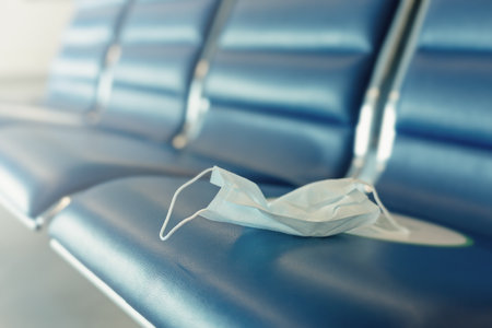 Used dirty medicine mask on seats in airport. New reality concept.の写真素材