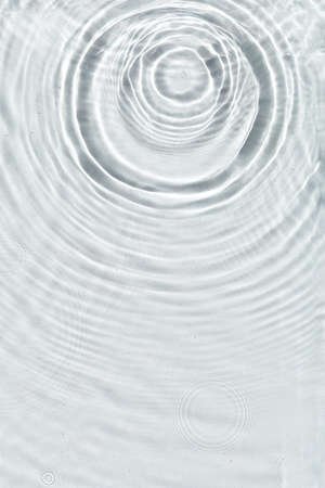 Abstract water texture, surface with drops, rings and ripple. Flat lay, top view, background with copy spaceの写真素材