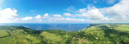 Baltic coastline with green summer forest and the sea. Aerial panorama view from droneの写真素材