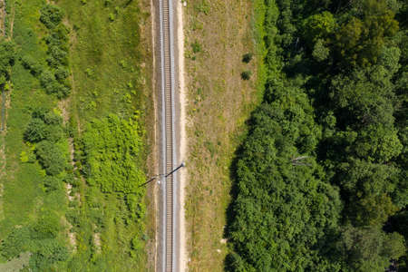 Railway through summer forest. Aerial view from droneの写真素材