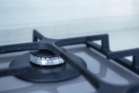 Contemporary built-in gas oven, empty hob closeup, copy space with kitchen interior background