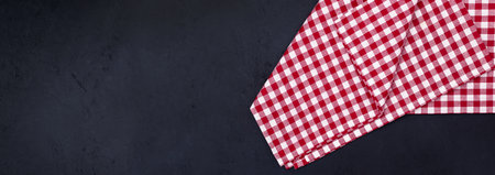 Table with red checkered tablecloth, free space for decoration and text, empty template for restaurant menu cardの写真素材