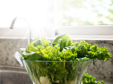 Green freshly washed kale cabbage in glass bowl in kitchen interior, nobodyの写真素材