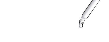 Drop of water falling from glass lab pipette isolated on white background. Macroの写真素材