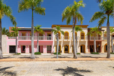 Empty streets in Cap Cana village with colorful houses, beautiful nature at sunny day. Luxury residence in Dominican Republicの写真素材