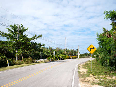 Traffic road sign turn right on empty highway without cars in Dominican Republic, nobodyの写真素材
