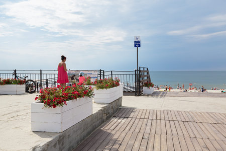 BALTIYSK, RUSSIA - JUNE 30, 2021: Beautiful public sandy beach with resting local people and touristsのeditorial素材