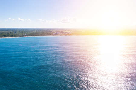 Sunset on wild tropical coastline with caribbean sea. beautiful travel destination. Aerial view from droneの写真素材