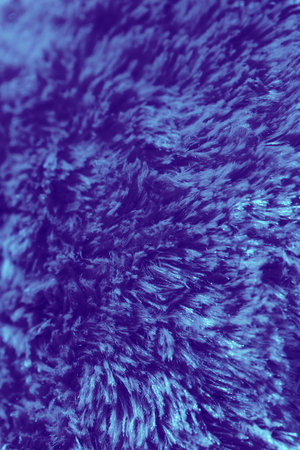 Violet fluffy abstract texture background with copy space. Fabric pattern backdrop, macro.