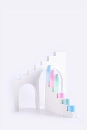 Pastel color cosmetic tubes on podium stairs, abstract trendy product advertisingの写真素材