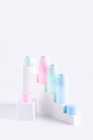 Pastel color cosmetic tubes on podium stairs, abstract trendy product advertisingの写真素材