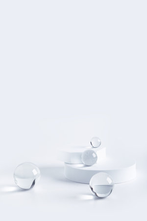 Product display with round podiums and glass sphere, copy spaceの写真素材