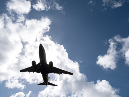 Airplane on sky and clouds background. Travel and transport concept