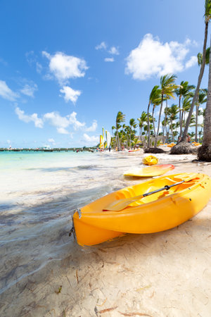 Bavaro beach in sunny day with calm Atlantic ocean and white sandy beach, focus on boat,  Dominican republicの写真素材