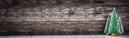 Spruce trees on wooden rustic background with snow. New Year celebration. winter holidays. long bannerの写真素材