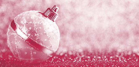 New year spruce tree decoration ball on shiny silver background. Christmas celebration. Viva Magenta color of the year 2023の写真素材
