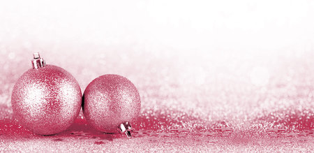 Christmas boubles on silver glitter with sparkling defocused lights on background. New Year greeting card. Viva Magenta color of the year 2023の写真素材