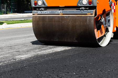 Road construction works with steamroller machine and asphalt finisher. Nobodyの写真素材