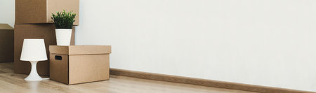 Crop of packaging boxes in apartment, moving concept. long bannerの写真素材