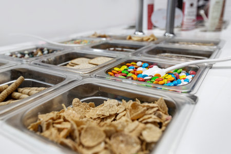 Different sweet toppings for desserts at food court, shallow depth and selective focusの写真素材