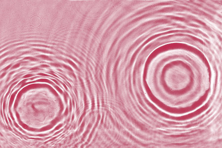 Abstract water texture, surface with drops, rings and ripple. Flat lay, top view, background with copy space. Viva Magenta color of the year 2023の写真素材
