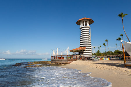 DOMINICAN REPUBLIC, BAYAHIBE - DECEMBER 16 2021: Lighthouse on Dominicus beach with Caribbean sea waves. travel destination backgroundのeditorial素材
