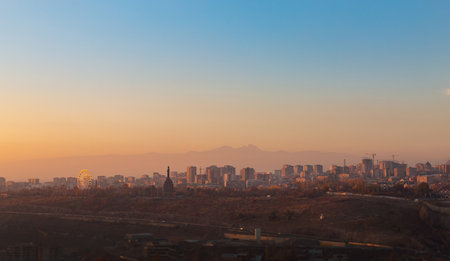 Mountain Ararat and Yerevan city view at sunrise, cityscape with selective focus on buildings, autumn seasonの写真素材