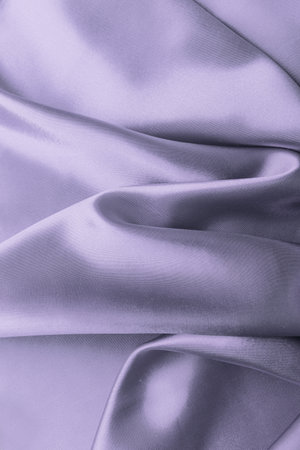 Violet color atlas material background, silk abstract textile surface, drapery clothの写真素材
