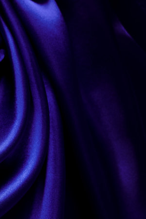 Blue atlas material background, silk abstract textile surface, drapery clothの写真素材