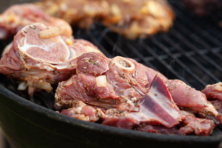 Cooking different meats on barbecue. Grilled and roasted lamb steaks on bbq. outdoorsの写真素材