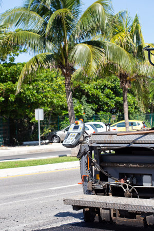Pavement truck laying fresh asphalt during road constructionの写真素材