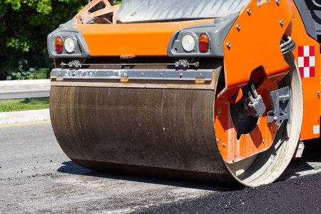 Road construction works with steamroller machine and asphalt finisher. Nobodyの写真素材