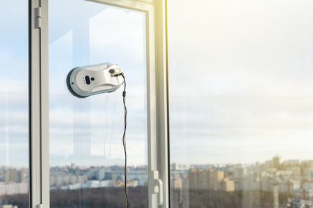 Smart vacuum cleaner washing windows. home appliance and technology concept.の写真素材