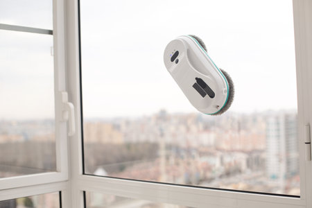 Smart vacuum cleaner washing windows. home appliance and technology conceptの写真素材