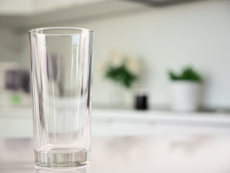 Clean water in glass on table at the kitchen, closeupの写真素材