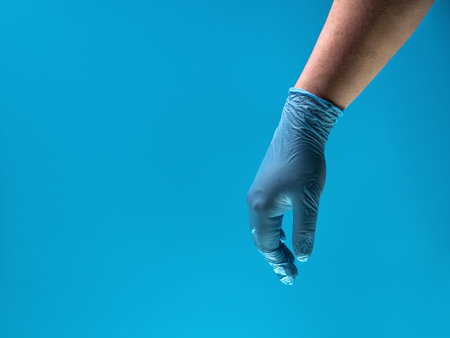 Man in blue latex gloves, closeupの写真素材