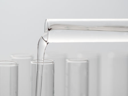 Transfuse liquid from one tube into laboratory test glass tube, nobody. Closeupの写真素材